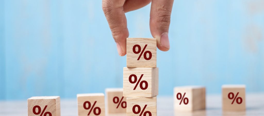 Business,Man,Hand,Putting,Wood,Cube,Block,With,Percentage,Symbol