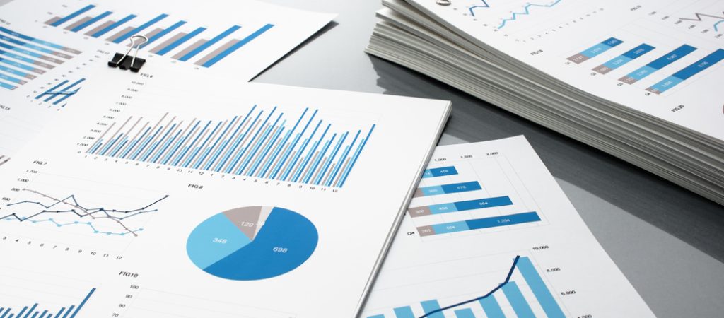 Preparing,Report.,Blue,Graphs,And,Charts.,Business,Reports,And,Pile